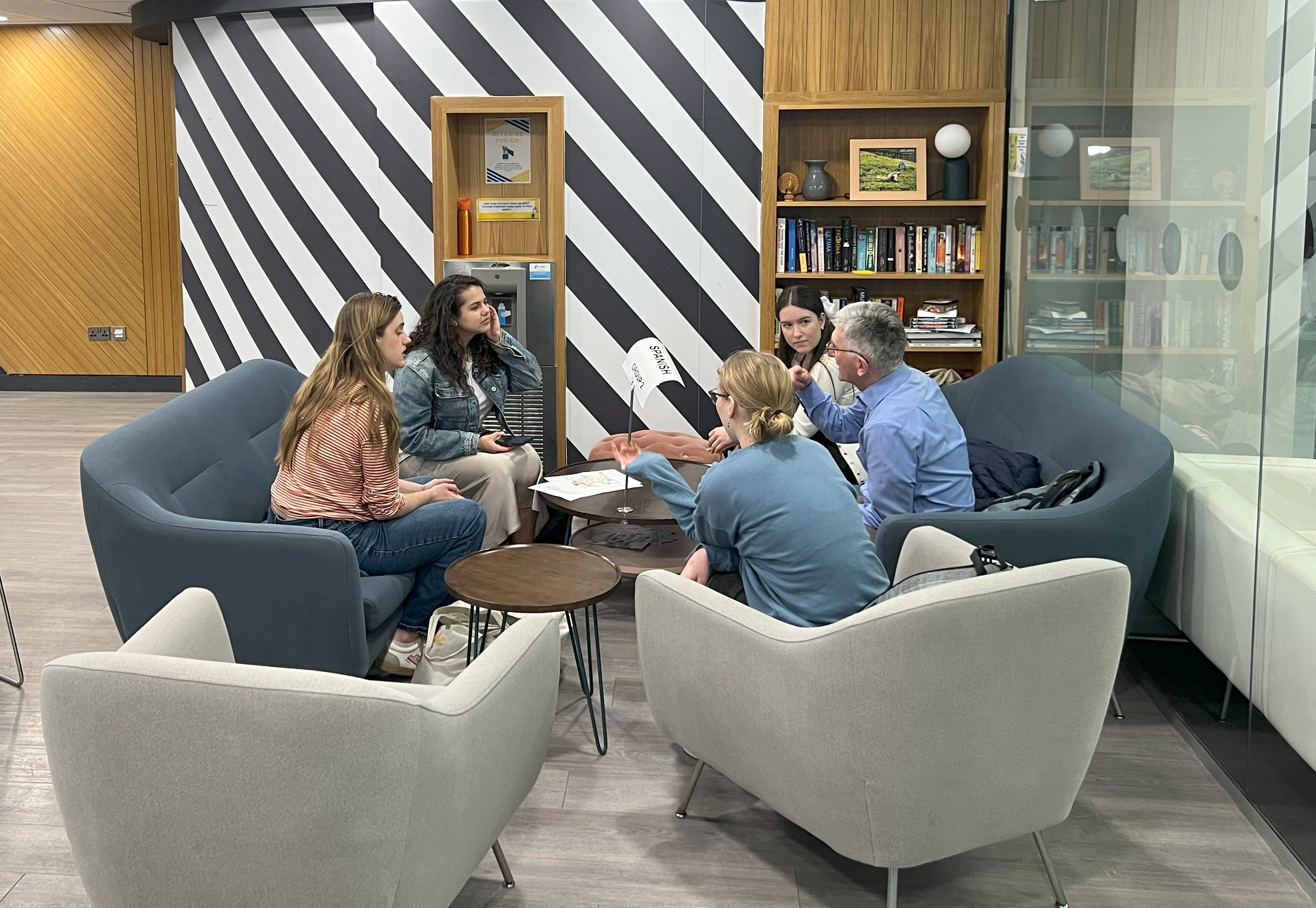 Students sitting around a table, talking.